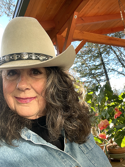 Author Carol Christen headshot in cowboy hat